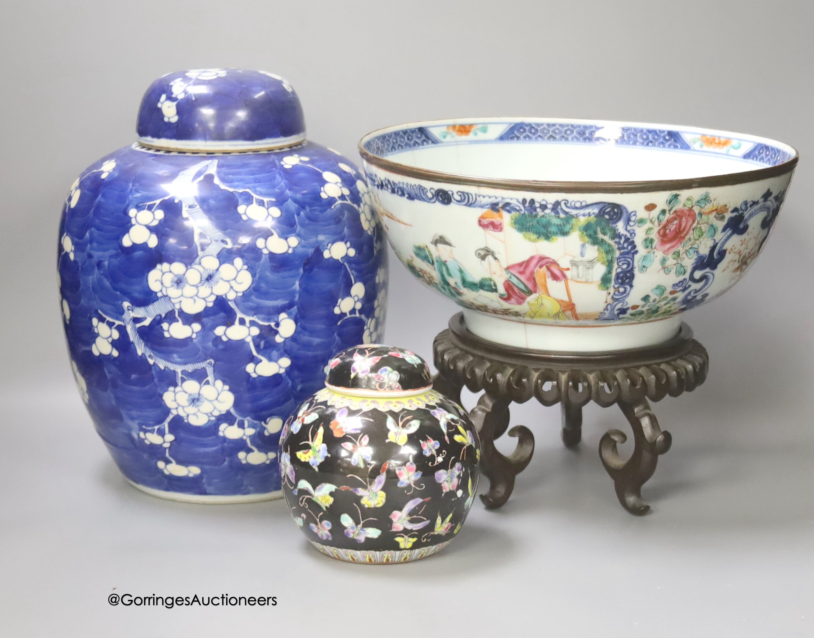 A 19th century Chinese porcelain prunus jar and cover, 27cm, on carved wood stand, a smaller famille noire jar and cover, a Chinese export fruit bowl, blue and white dish and a similar jar and cover 27cm
